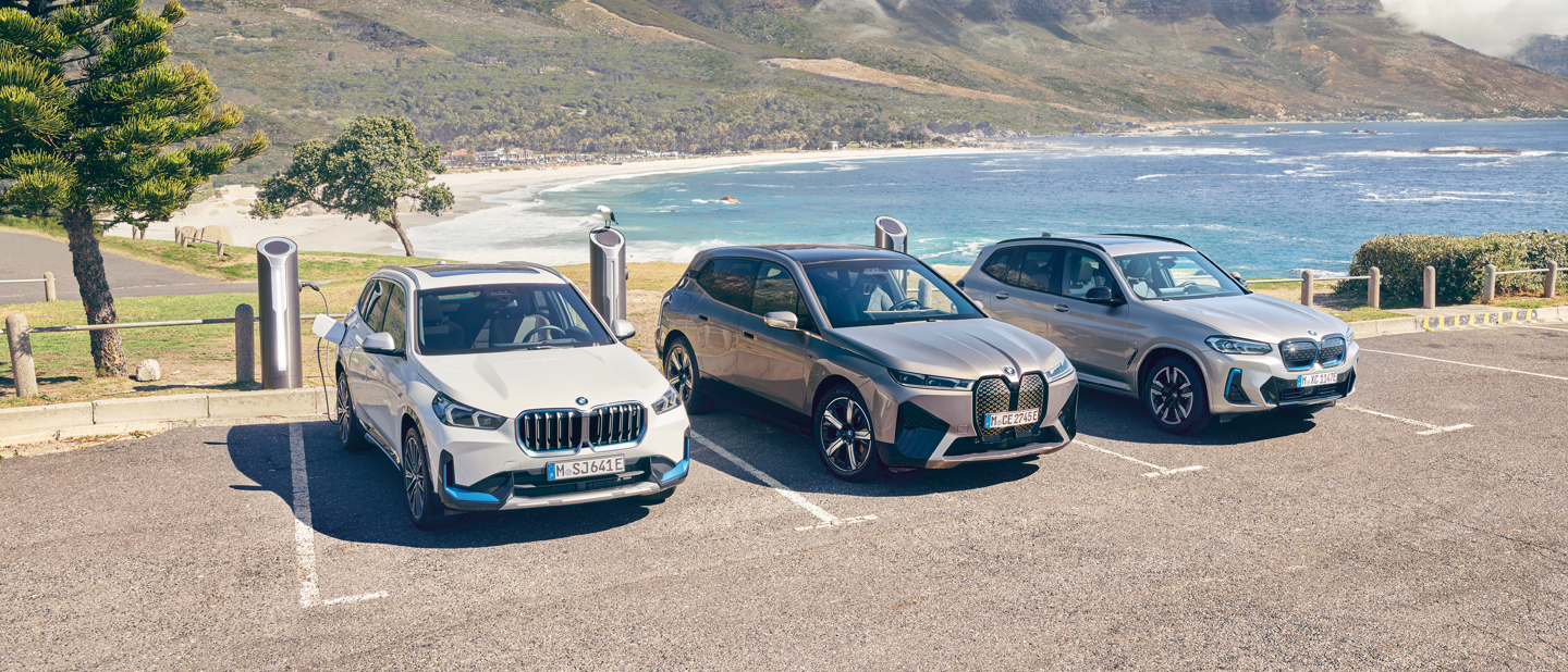 Tre elektriske SUV'er fra BMW holder til opladning nær strand