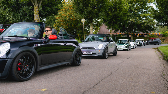 En række MINI'er kører i kortege.