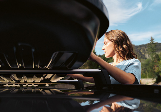 Bayern AutoGroup-mekaniker med tagboks på taget af sin bil